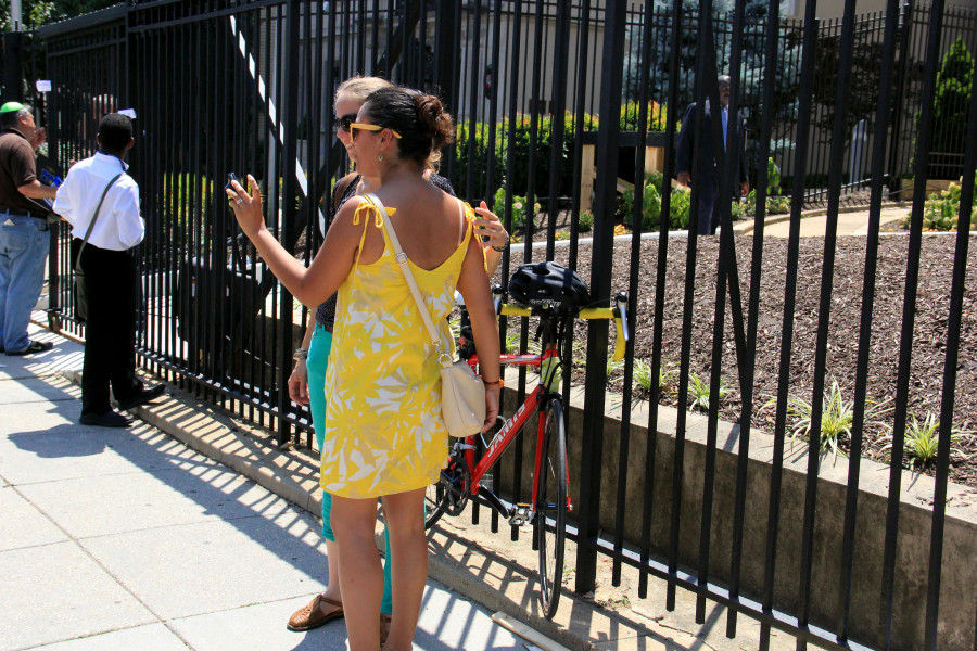 Two women pose for a selfie in front of the Cuban Embassy in Washington on July 20, 2015. (Jennifer-Leigh Oprihory/MEDILL NSJI)