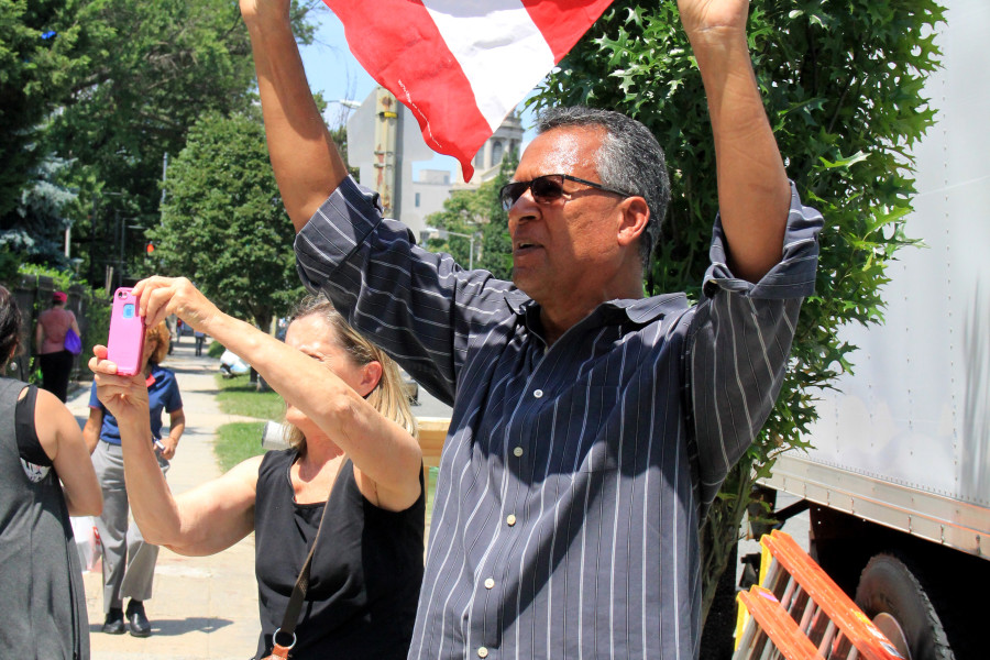 Oswald Cameron holds up a Puerto Rican flag outside of the Cuban Embassy in Washington on July 20, 2015. (Jennifer-Leigh Oprihory/MEDILL NSJI)