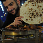 One of our IYLEP students, Ahmad Khalid, prepares for a feast at Dawa 2 Restaurant in Erbil, Iraq. Alix Hines/MEDILL