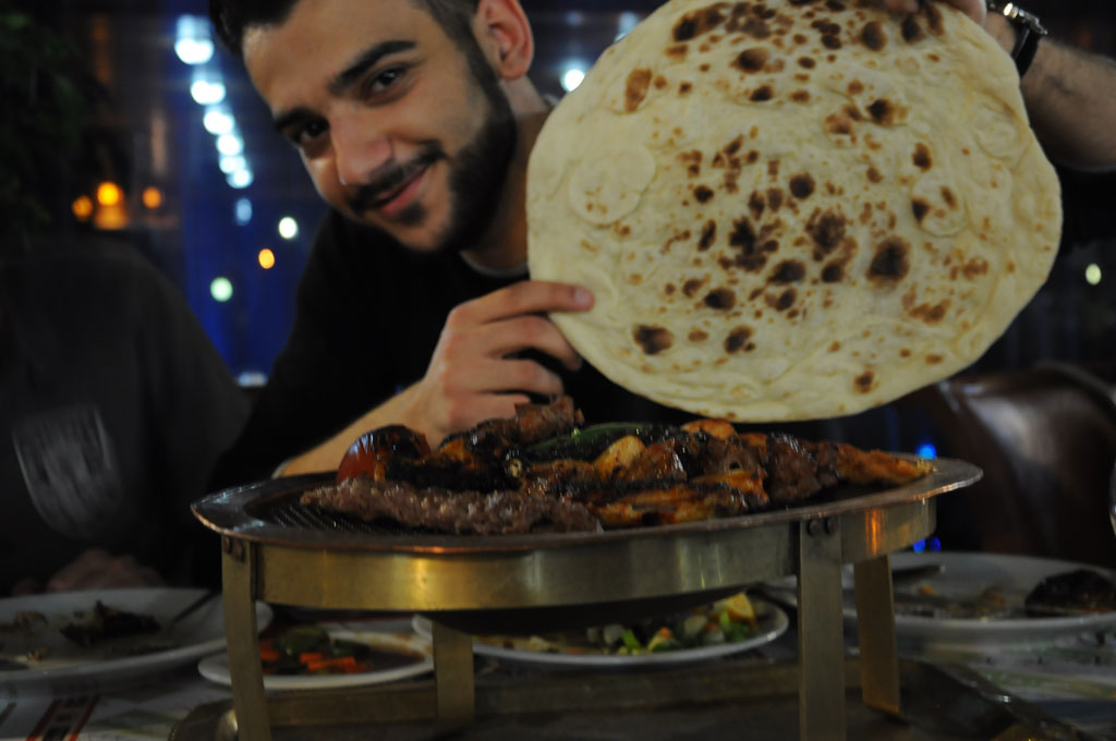 One of our IYLEP students, Ahmad Khalid, prepares for a feast at Dawa 2 Restaurant in Erbil, Iraq. Alix Hines/MEDILL