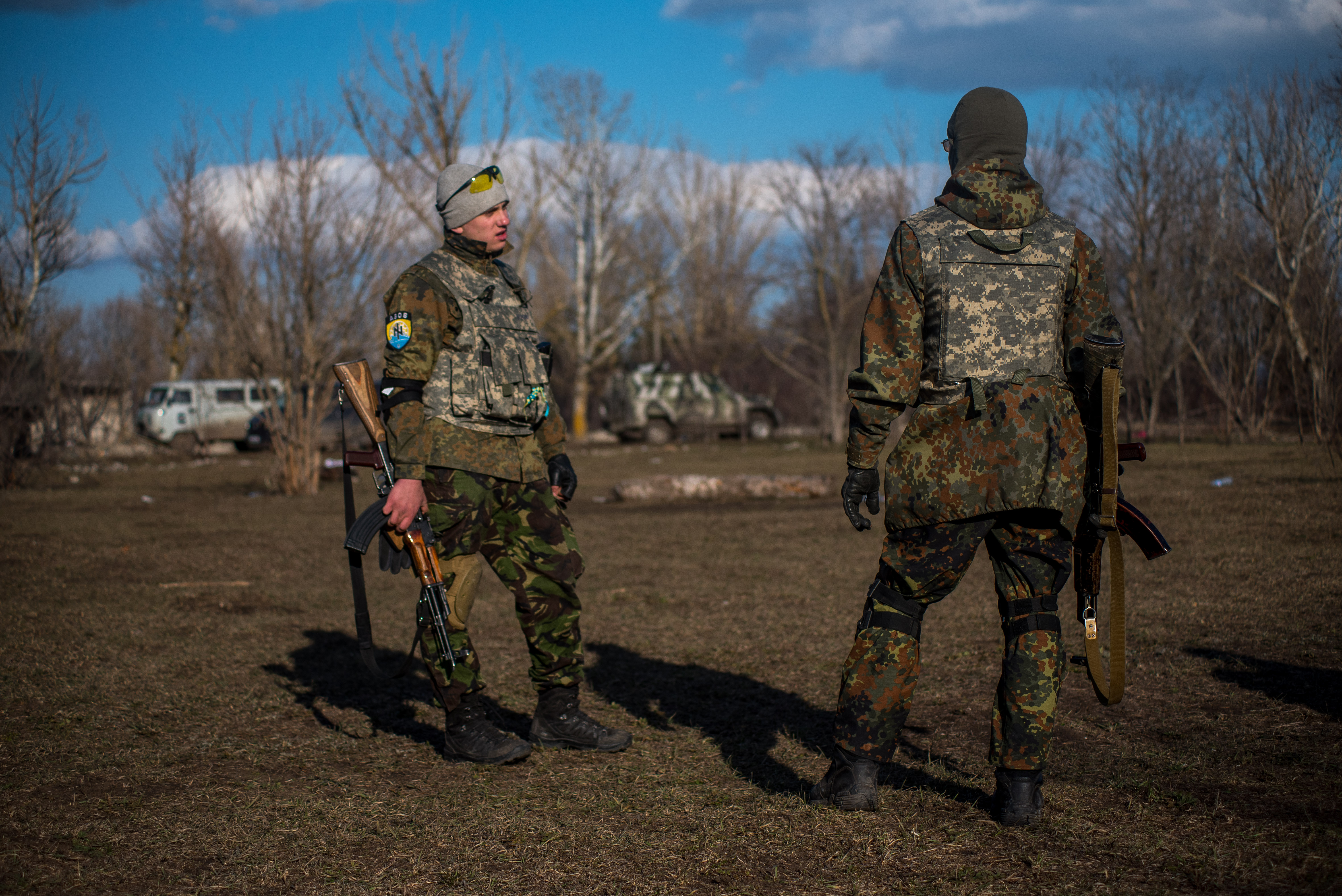 3/6: Members of the Azov Battalion take a break from a training exercise near Mariupol. Note the battalion’s Runic symbol on the arm of the fighter on the left. (Photo Credit: James Sprankle)