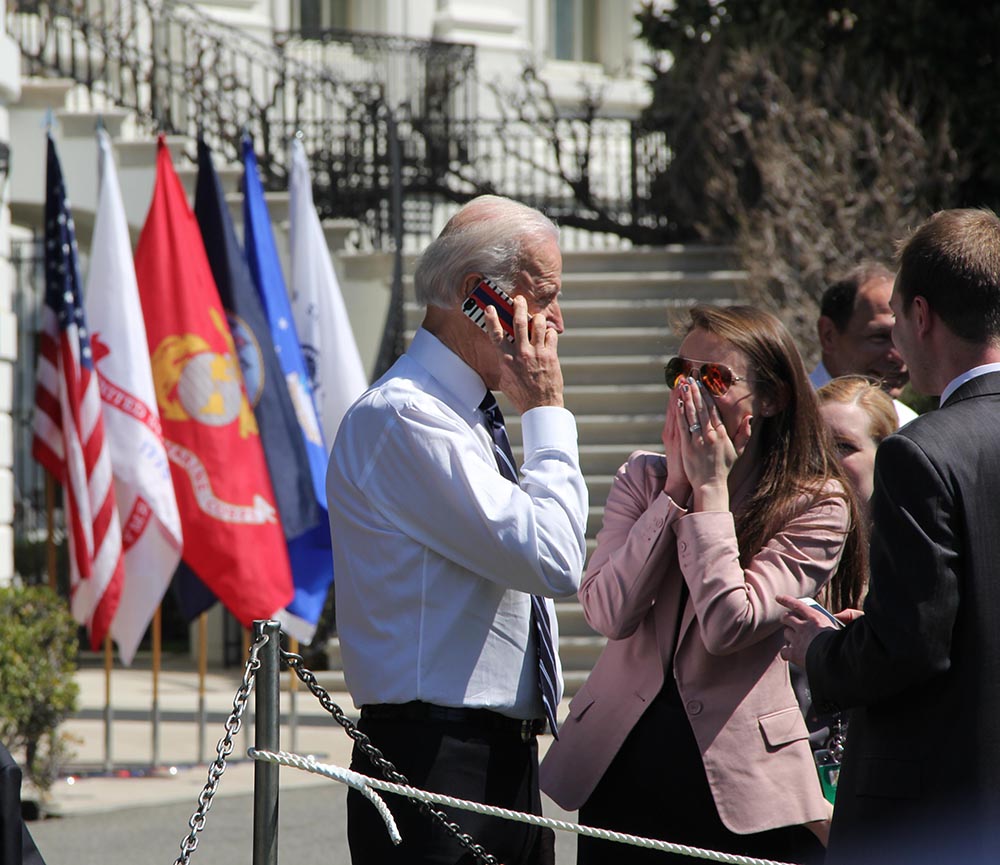 Vice President Joe Biden makes a call for spectator Elizabeth Welke to her husband after the Soldier Ride. (Nick Kariuki/MEDILL)
