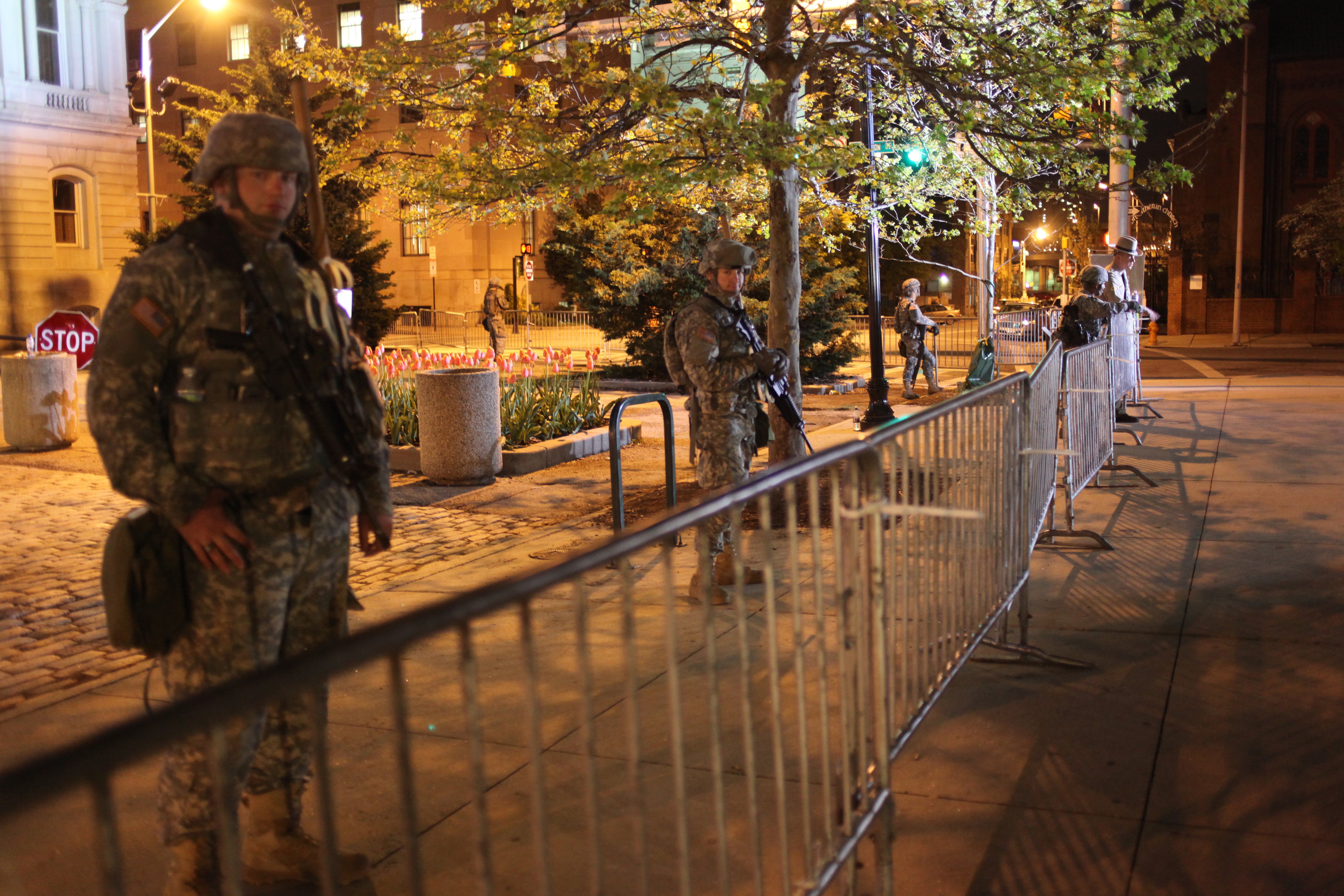 Maryland Army National Guard soldiers line a barricade in front of Baltimore City Hall on April 30, 2015. (Jennifer-Leigh Oprihory/MEDILL NSJI)