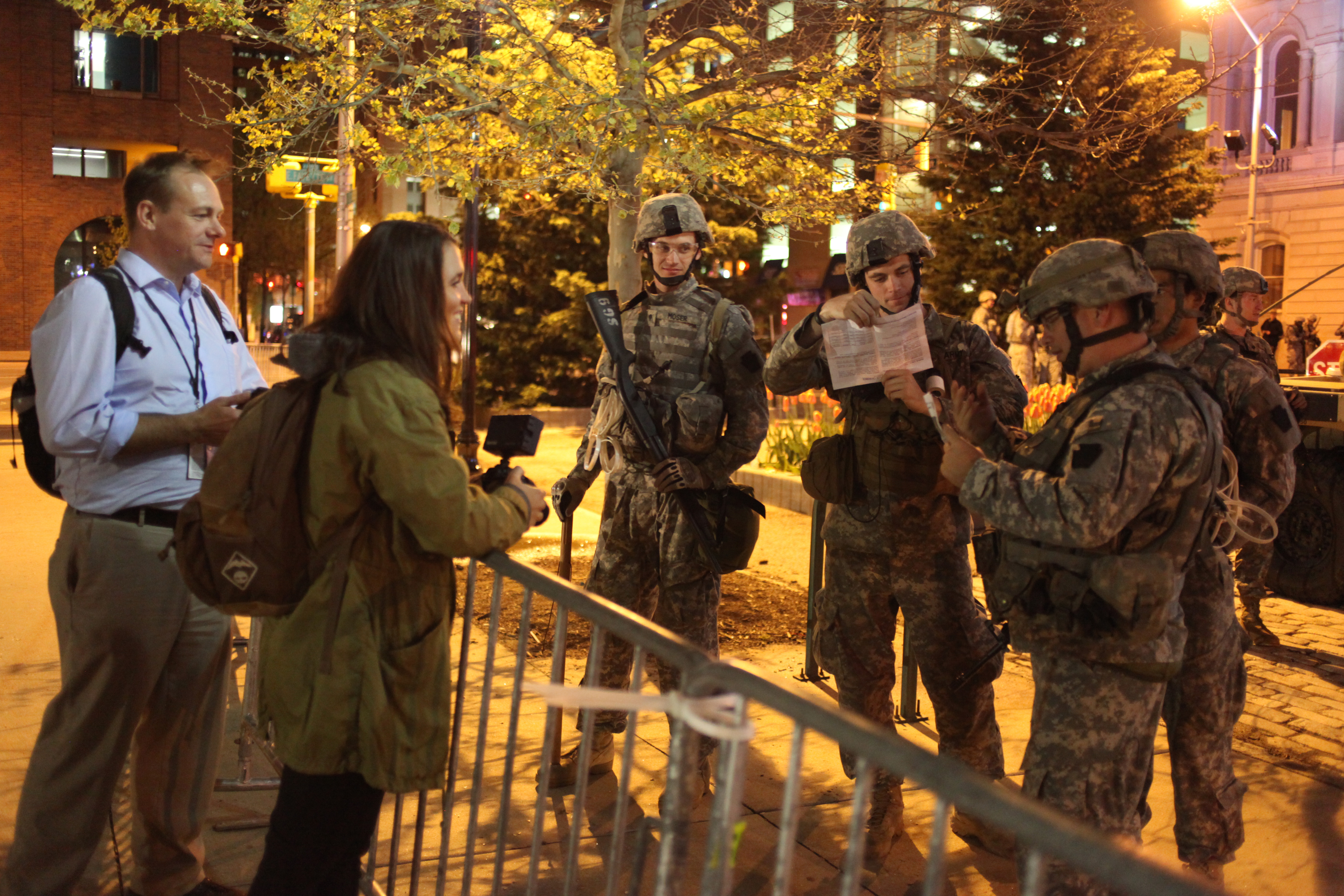 Medill National Security Specialization students Matthew Schehl and Jenny Leonard speak with Maryland Army National Guard soldiers in front of Baltimore City Hall on April 30, 2015. (Jennifer-Leigh Oprihory)