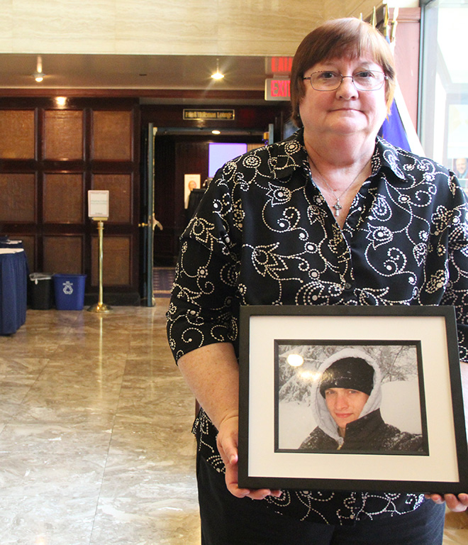 Deborah Paugh displays a picture of her son, Peter Lapa-Killy, who killed himself with a firearm in April 2012 after a misunderstanding with his longtime girlfriend. (Yinmeng Liu/MEDILL NSJI)