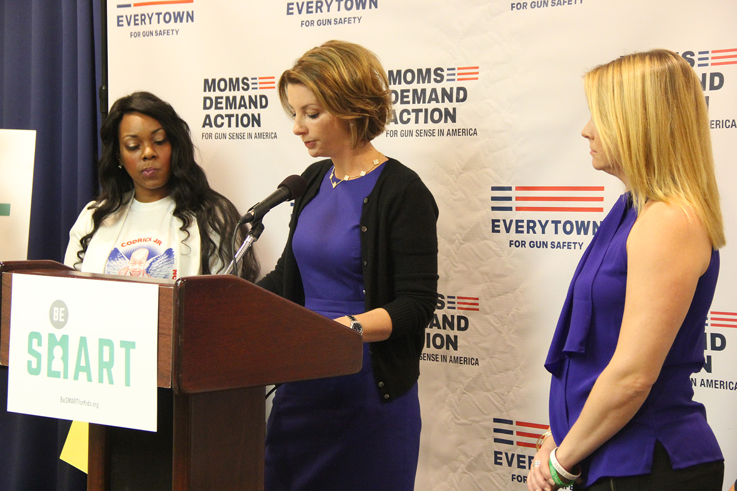Shannon Watts, the founder of Moms Demand Action for Gun Sense in America, speaks at a conference in Washington D.C. on May 4, 2015, while actress Melissa Joan Hart and Ashley Beal look on. Hart and Beal were both speakers at the event. (Yinmeng Liu/MEDILL NSJI)