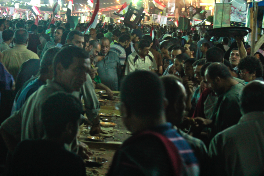 Supporters of ousted Egyptian President Mohammed Morsi push to get a free meal in the tent city near the mosque in Rabaa, in Cairo, Egypt. During the holy month of Ramadan Muslims refrain from food and drink from sunrise to sunset. (Amina Ismail/MCT)