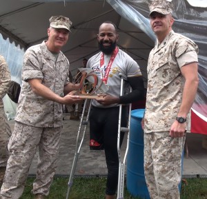 Retired Army Staff Sergeant, Alfredo “Freddy” De Los Santos awarded the 40th Marine Corps Marathon, 1st place hand cyclist trophy.  (Angela G. Barnes/Medill NSJI)
